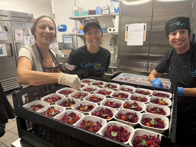 Ladies doing meal prep in the Culinary Angels kitchen